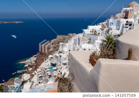 White Cycladic buildings on Oia cliffside overlooking Santorini caldera White Cycladic buildings on Oia cliffside overlooking Santorini caldera 141057589