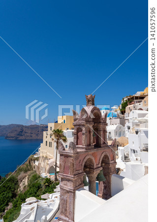 Historic pink stone bell tower in Oia village Santorini Greece Historic pink stone bell tower in Oia village Santorini Greece 141057596