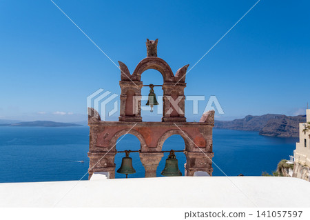 Symmetrical view of traditional pink bell tower in Oia Santorini Symmetrical view of traditional pink bell tower in Oia Santorini 141057597