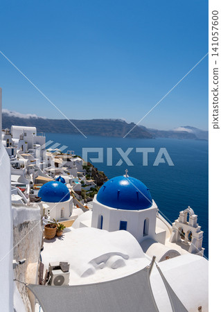 Famous blue domes and white buildings of Oia Santorini Greece Famous blue domes and white buildings of Oia Santorini Greece 141057600