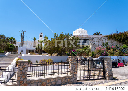 White orthodox church building with stone fence in Santorini Greece White orthodox church building with stone fence in Santorini Greece 141057602