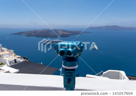 Blue coin operated binoculars overlooking Santorini volcanic caldera Blue coin operated binoculars overlooking Santorini volcanic caldera 141057604