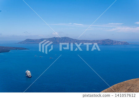 Cruise ship near Thirasia island in Santorini volcanic caldera Cruise ship near Thirasia island in Santorini volcanic caldera 141057612