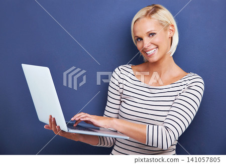 Woman, portrait and smile with laptop in studio for internet connectivity for online email, networking or blue background. Female person, face and technology for research blog, subscription or mockup Woman, portrait and smile with laptop in studio for internet connectivity for online email, networking or blue background. Female person, face and technology for research blog, subscription or mockup 141057805