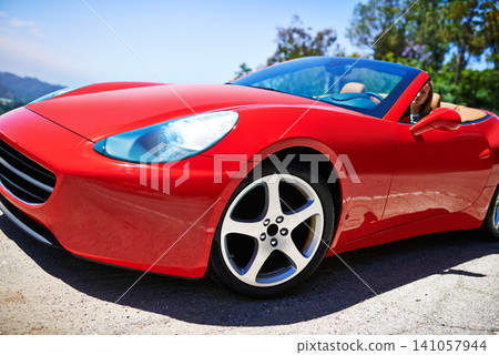Luxury, sports car and driving closeup with wheel in city, outdoor in summer and person on road trip. Red, convertible and rich driver with transport to travel on highway and vehicle on street Luxury, sports car and driving closeup with wheel in city, outdoor in summer and person on road trip. Red, convertible and rich driver with transport to travel on highway and vehicle on street 141057944