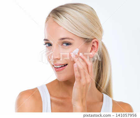 Woman, portrait and hand for skincare cream or dermatology health, wellbeing or treatment. Female person, facial and lotion self care or sunscreen protection on studio, white background or mockup Woman, portrait and hand for skincare cream or dermatology health, wellbeing or treatment. Female person, facial and lotion self care or sunscreen protection on studio, white background or mockup 141057956