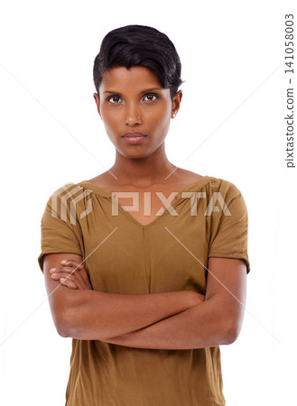 Indian woman, fashion and arms crossed in studio portrait with confidence, pride and serious by white background. Girl, person and cool model with edgy outfit, shirt and trendy style in Mumbai 141058003