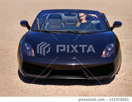 Woman, black sports car and outdoors on road trip, mountain and luxury transport on summer drive. Female person, holiday and countryside wellness on gravel street, vacation and adventure in vehicle Woman, black sports car and outdoors on road trip, mountain and luxury transport on summer drive. Female person, holiday and countryside wellness on gravel street, vacation and adventure in vehicle 141058065