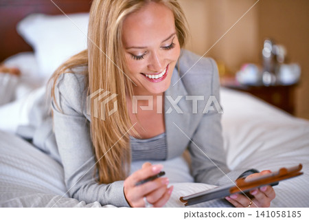 Business, woman and technology in bedroom with research for corporate planning, digital tablet and work schedule. Professional, person and happy for writing review notes and internet search in hotel Business, woman and technology in bedroom with research for corporate planning, digital tablet and work schedule. Professional, person and happy for writing review notes and internet search in hotel 141058185