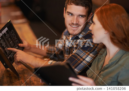 Happy couple, restaurant and reading with menu for option, choice or decision on romantic dinner date. Man and woman with smile for meal, selection or pick on price list at indoor coffee shop or cafe Happy couple, restaurant and reading with menu for option, choice or decision on romantic dinner date. Man and woman with smile for meal, selection or pick on price list at indoor coffee shop or cafe 141058206