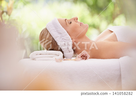 Woman, spa and break for zen, peace and wellness with relaxation and calm. Lady, towel and massage table at resort, lounge or luxury parlor with rose for holistic body and skincare for detox and rest Woman, spa and break for zen, peace and wellness with relaxation and calm. Lady, towel and massage table at resort, lounge or luxury parlor with rose for holistic body and skincare for detox and rest 141058282