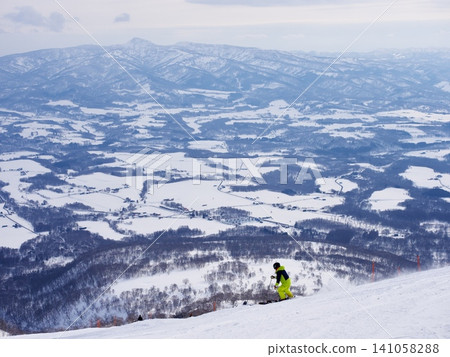 Skiers skiing down Wonderland at Niseko Village Ski Resort Skiers skiing down Wonderland at Niseko Village Ski Resort 141058288