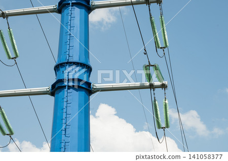 High voltage power line tower against blue sky High voltage power line tower against blue sky 141058377