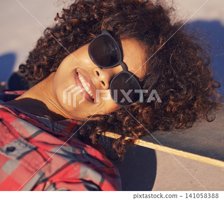 Black woman, outdoor and smile with sunglasses on skateboard for training and relax in Atlanta . Closeup, female person and skater with hobby or sport for fitness, health and fun at skatepark Black woman, outdoor and smile with sunglasses on skateboard for training and relax in Atlanta . Closeup, female person and skater with hobby or sport for fitness, health and fun at skatepark 141058388