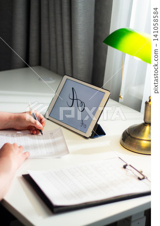 Woman sitting at desk and writing with pen. Handwriting boosts memory retention concept. Close up of pen on paper, deep concentration, analog study habits for better learning Woman sitting at desk and writing with pen. Handwriting boosts memory retention concept. Close up of pen on paper, deep concentration, analog study habits for better learning 141058584