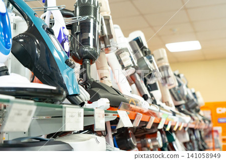 Variety of Modern Vacuum Cleaners Displayed on Retail Shelves, Showcasing Diverse Designs and Technologies for Efficient Home Cleaning Variety of Modern Vacuum Cleaners Displayed on Retail Shelves, Showcasing Diverse Designs and Technologies for Efficient Home Cleaning 141058949