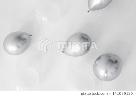 Top View Of Chrome And Translucent Balloons On White Surface Top View Of Chrome And Translucent Balloons On White Surface 141059130