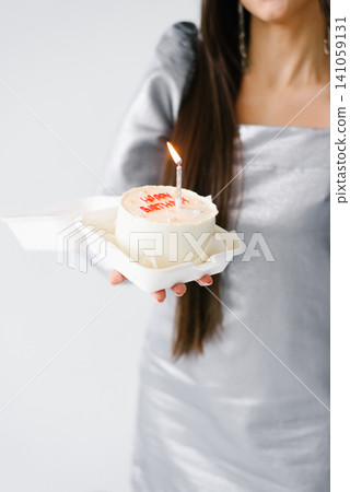 Bento Cake with Birthday Candle Held by Woman Bento Cake with Birthday Candle Held by Woman 141059131