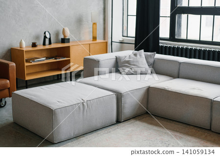 Stylish Apartment Interior with Grey Sectional Couch and Wooden Cabinet Stylish Apartment Interior with Grey Sectional Couch and Wooden Cabinet 141059134