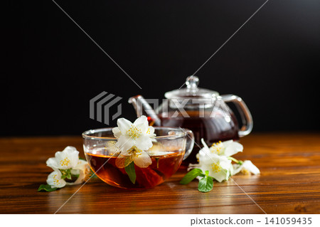 jasmine flower tea in glass cup with teapot jasmine flower tea in glass cup with teapot 141059435
