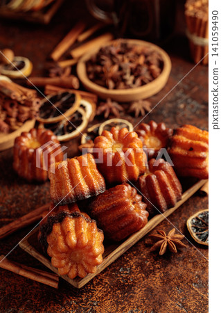 Cinnamon cakes in wooden dish on a brown background. Cinnamon cakes in wooden dish on a brown background. 141059490