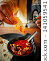 Indian Chicken Curry with Roti Flatbread and Toasted Bread on Wooden Table 141059541