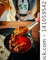 Indian Chicken Curry with Roti Flatbread and Toasted Bread on Wooden Table 141059542