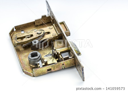 Detailed Closeup of Disassembled Mortise Door Lock Mechanism Revealing Internal Brass Components, Springs, Latch Bolt and Cylinder Housing on Clean White Background Studio Shot Detailed Closeup of Disassembled Mortise Door Lock Mechanism Revealing Internal Brass Components, Springs, Latch Bolt and Cylinder Housing on Clean White Background Studio Shot 141059573