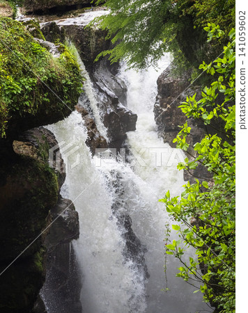 Scenic landscape of a powerful river flowing through a lush green stone gorge Scenic landscape of a powerful river flowing through a lush green stone gorge 141059602