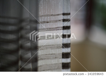 Soft blurred view of striped window curtain fabric Soft blurred view of striped window curtain fabric 141059643