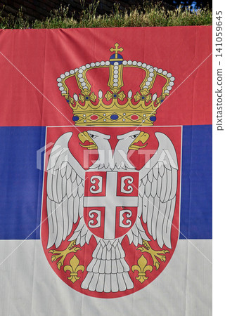 Serbia flag with coat of arms outdoors Serbia flag with coat of arms outdoors 141059645