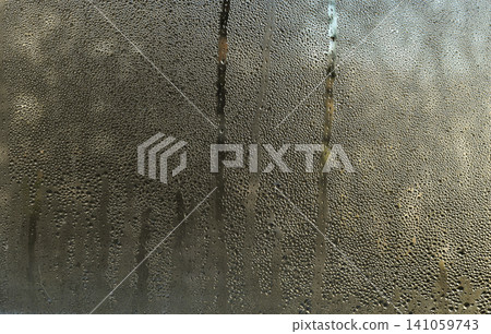 Condensation covering glass surface with water droplets and vertical streaks, Condensation covering glass surface with water droplets and vertical streaks, 141059743