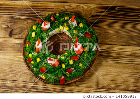 Salad Christmas wreath on a wooden table. Top view Salad Christmas wreath on a wooden table. Top view 141059912