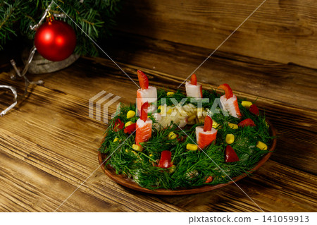 Salad Christmas wreath on a wooden table Salad Christmas wreath on a wooden table 141059913
