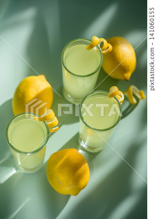 Lemon cocktails refreshing summer drink with citrus peel garnish 141060155