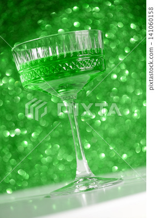 Green cocktail in crystal glass with sparkling background Green cocktail in crystal glass with sparkling background 141060158