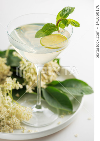 Elderflower cocktail with lime and mint on white background Elderflower cocktail with lime and mint on white background 141060176