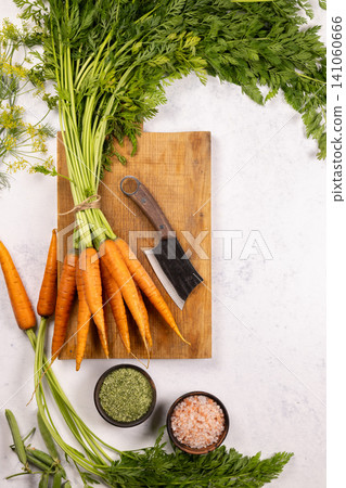 Fresh carrots with cleaver, food prep ingredients Fresh carrots with cleaver, food prep ingredients 141060666