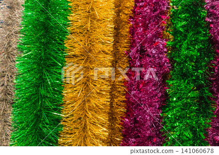 Christmas bright colored tinsel decor christmas background decorations colorful vibrant festive object Christmas bright colored tinsel decor christmas background decorations colorful vibrant festive object 141060678