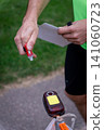 an orienteering athlete using an electronic timing punch 141060723