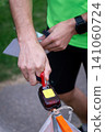 an orienteering athlete using an electronic timing punch 141060724