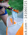 an orienteering athlete using an electronic timing punch 141060725