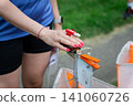 Female hand punching an electronic timing device at an orienteering control point 141060726
