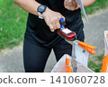 an orienteering athlete using an electronic timing punch 141060728