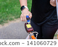 an orienteering runner holding a map and electronic timing chip 141060729