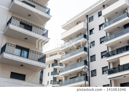 Multi storey residential building suburb city, house background sunny summer day Multi storey residential building suburb city, house background sunny summer day 141061046