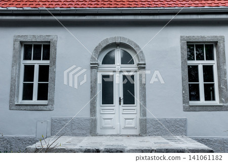 Entrance door small residential house in neighborhood, exterior building outside Entrance door small residential house in neighborhood, exterior building outside 141061182