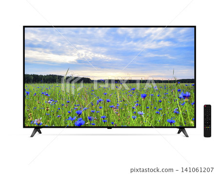 Smart tv with blue cornflowers field on screen and remote control isolated Smart tv with blue cornflowers field on screen and remote control isolated 141061207