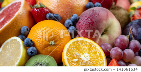 Fresh Assorted Fruits Background with Citrus, Berries and Grapes Fresh Assorted Fruits Background with Citrus, Berries and Grapes 141061634