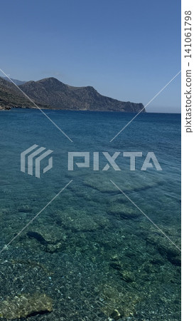 Scenic View of Clear Blue Sea and Rocky Coastline Scenic View of Clear Blue Sea and Rocky Coastline 141061798